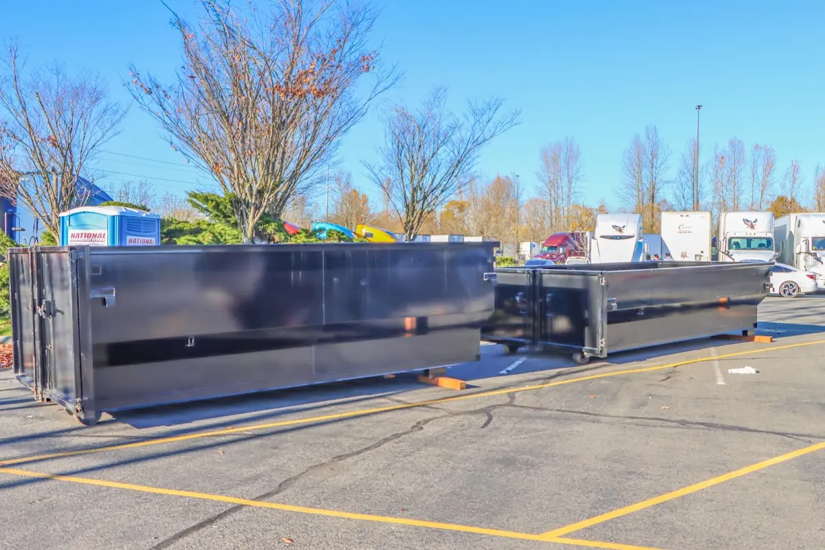 Professional dumpster rental service with roll-off container on residential driveway in Foxborough